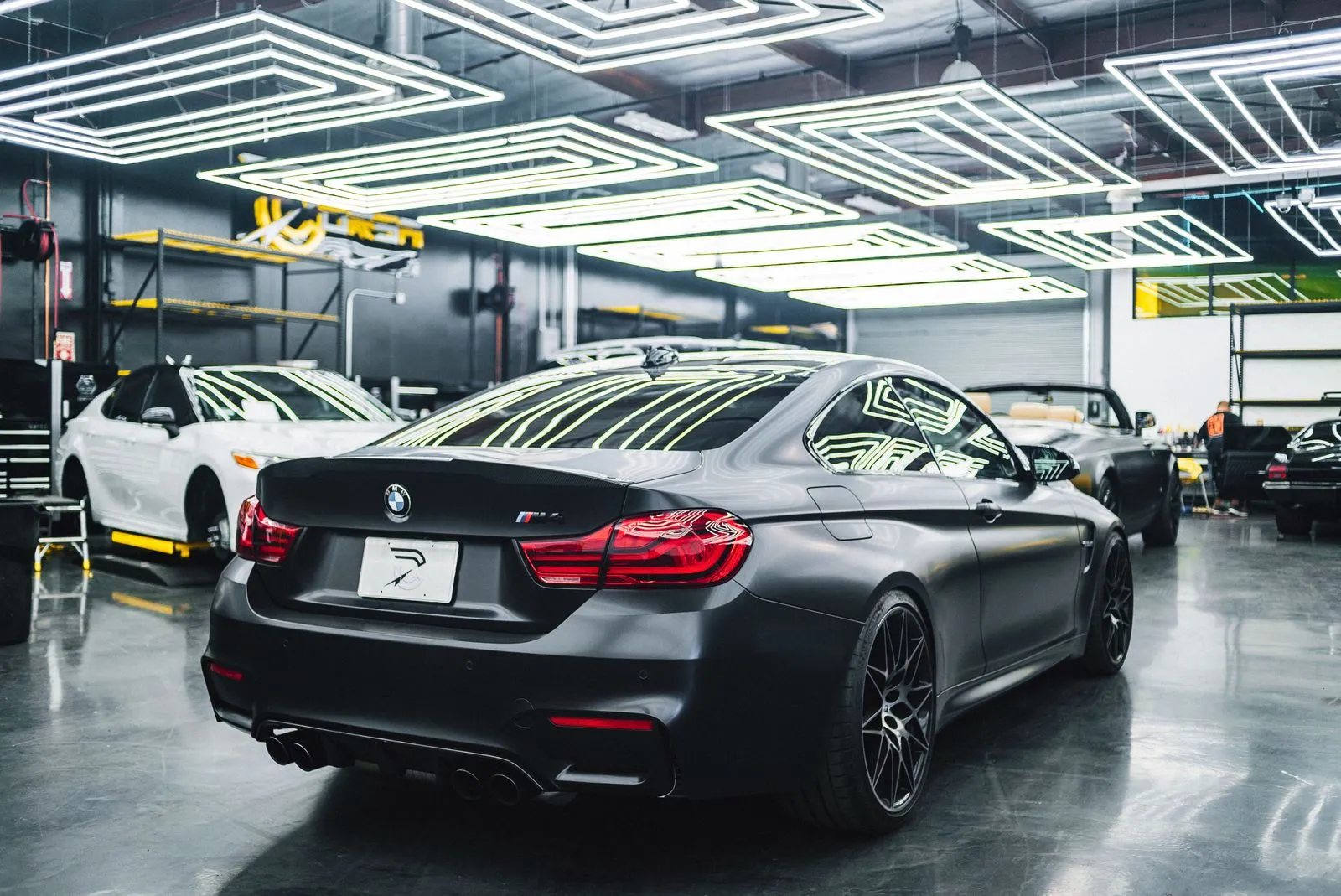 Cars parked inside a well-lit service bay